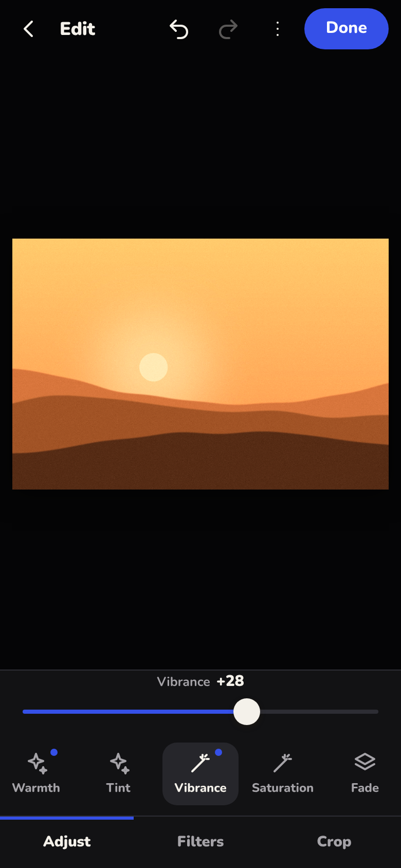 Lens on a phone, developing a photo of golden hills with the vibrance slider raised